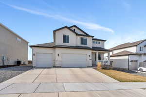 View of front of property featuring concrete driveway, stucco siding, central AC unit, a garage, and covered porch