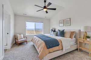 Bedroom with a ceiling fan, visible vents, carpet floors, lofted ceiling, and baseboards