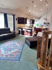 Living room with recessed lighting, lofted ceiling, and carpet floors