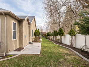 View of yard featuring a fenced backyard, and a patio area