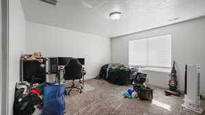 Interior space with visible vents, baseboards, and a textured ceiling