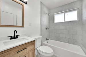 Bathroom with toilet, shower / bath combination, and vanity