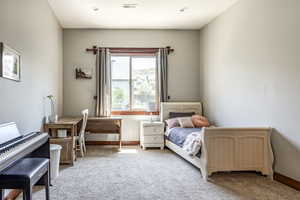Carpeted bedroom with baseboards