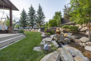 View of grassy yard with a garden pond