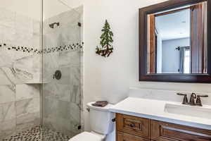 Bathroom featuring vanity and tiled shower