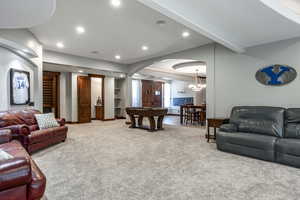 Living area with carpet floors, arched walkways, recessed lighting, and a chandelier