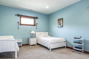Carpeted bedroom featuring baseboards