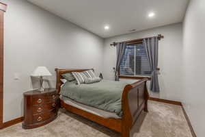 Carpeted bedroom with baseboards and recessed lighting