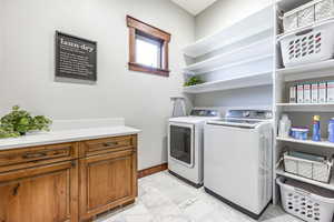 Washroom with separate washer and dryer and light marble finish flooring