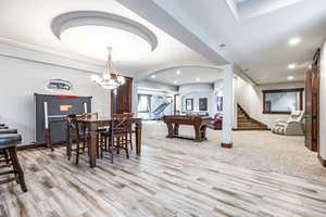 Dining area with stairs, arched walkways, light wood-style flooring, billiards table, and recessed lighting