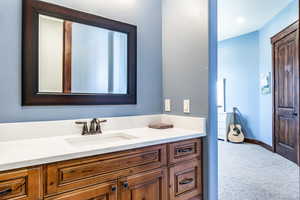 Bathroom featuring vanity and baseboards