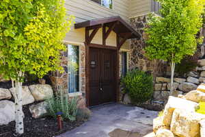 Doorway to property featuring stone siding