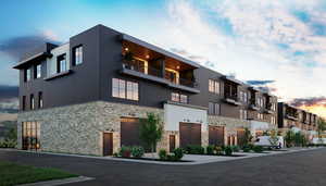 View of property at dusk