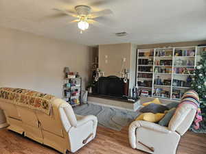 Living room with wood finished floors and a ceiling fan