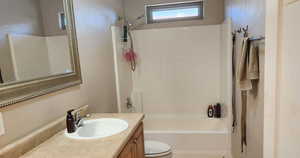 Bathroom with vanity and shower / washtub combination