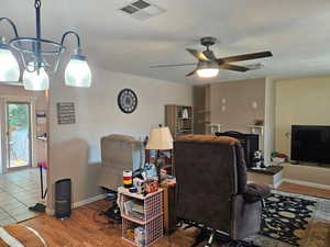 Living room with ceiling fan and wood finished floors