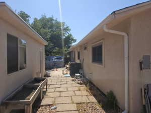 View of home's exterior with stucco siding and a patio