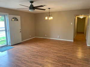 Entryway featuring a chandelier, wood finished floors, and a ceiling fan