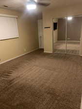 Unfurnished bedroom featuring carpet, a closet, and ceiling fan