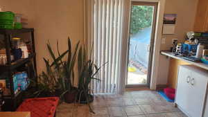 Entryway with light tile patterned floors