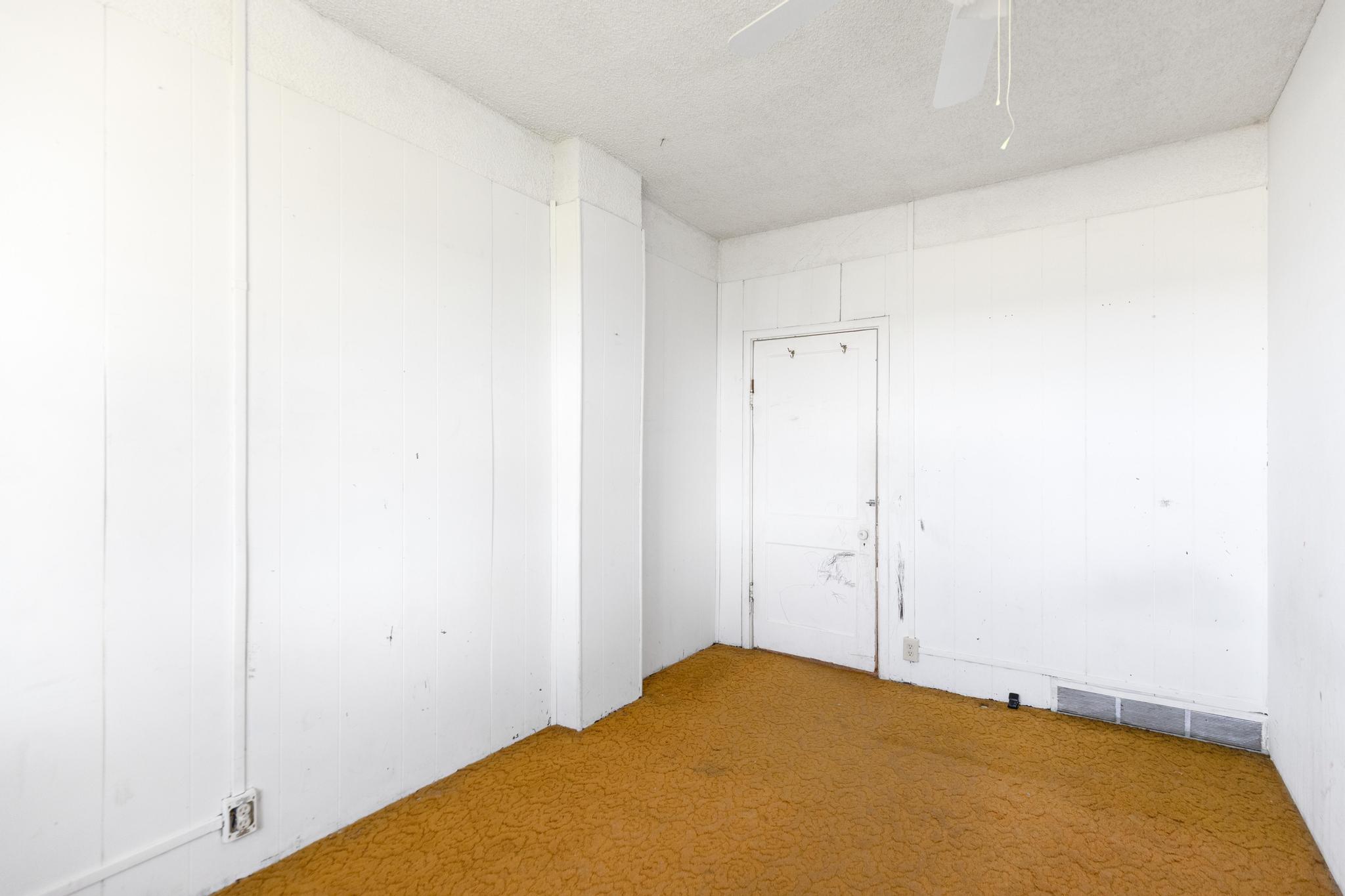 Empty room with a ceiling fan, carpet, and visible vents