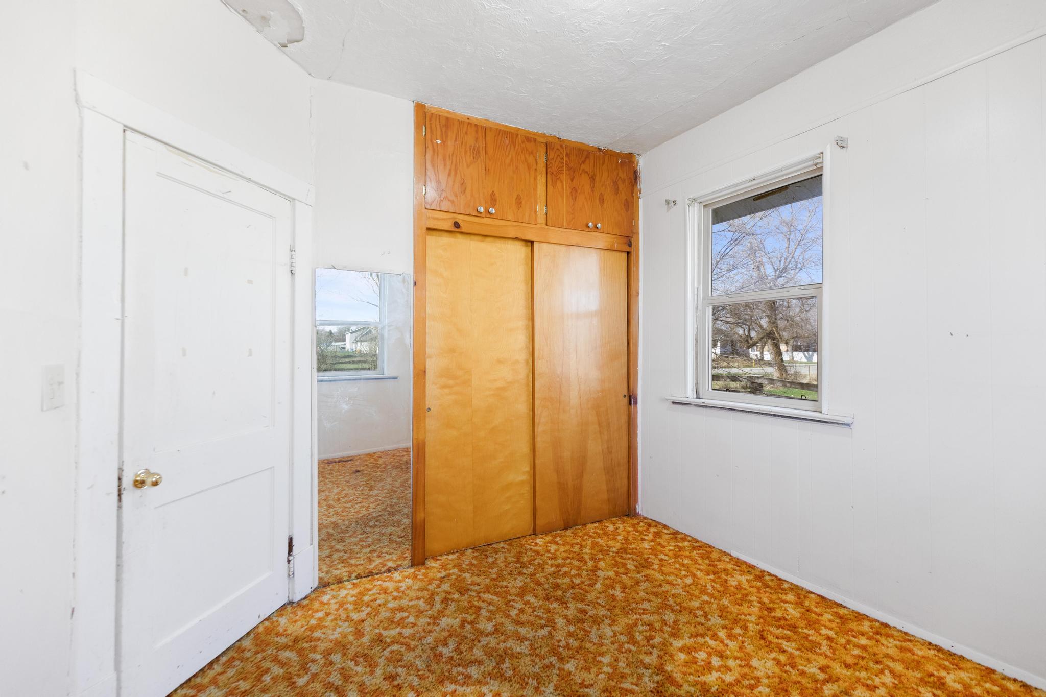 Unfurnished bedroom featuring a closet, a textured ceiling, and carpet