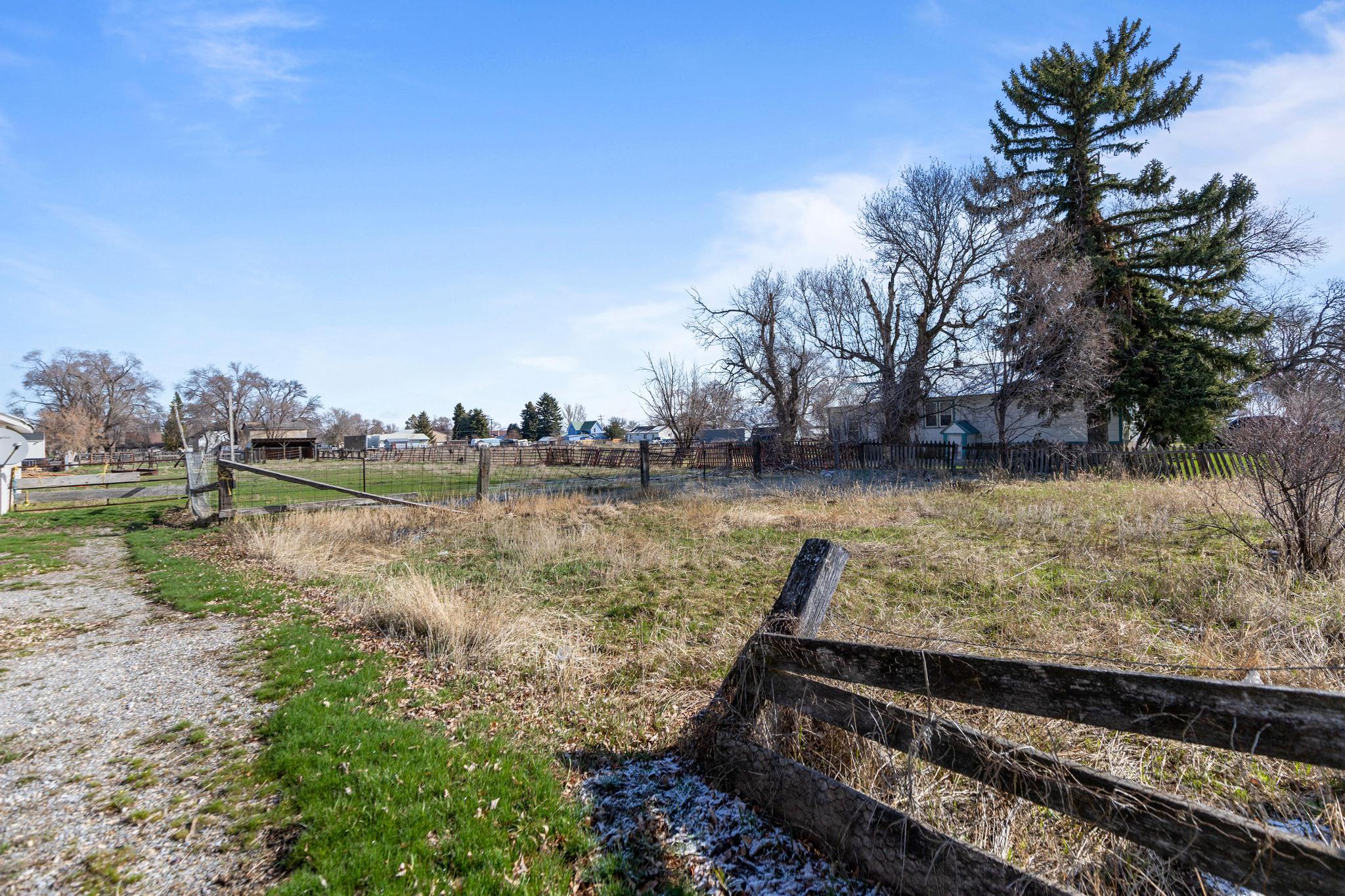 View of yard featuring fence and a rural view