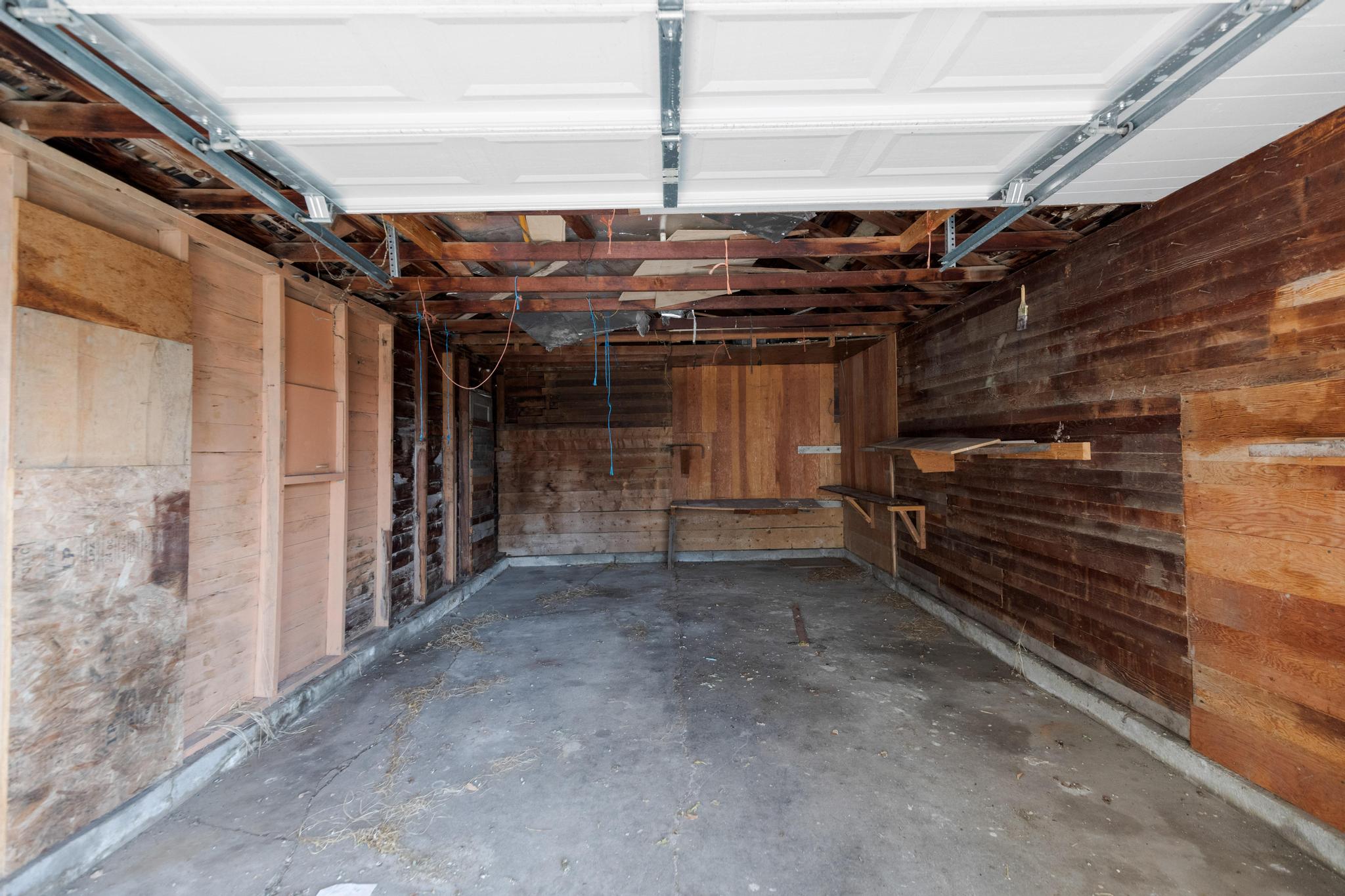 Garage featuring wood walls