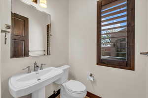 Half bathroom featuring a sink and toilet