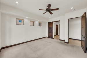 Unfurnished bedroom with recessed lighting, light colored carpet, and baseboards