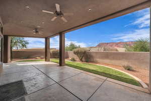 View of patio / terrace with ceiling fan and a fenced backyard