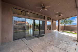 View of patio featuring fence and ceiling fan