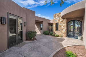 Doorway to property featuring french doors and stone siding