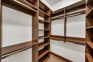 Walk in closet featuring carpet flooring