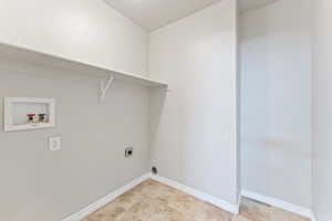 Laundry area featuring baseboards, electric dryer hookup, hookup for a washing machine, and laundry area