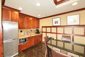 Kitchen featuring recessed lighting, a sink, stainless steel fridge, decorative backsplash, and built in microwave