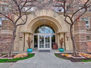 View of exterior entry featuring french doors and stone siding