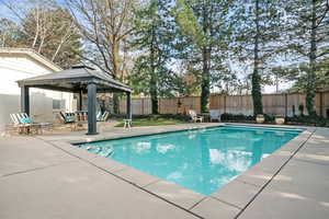 View of swimming pool featuring a fenced in pool, a patio area, a gazebo, and a fenced backyard