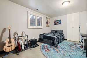 Bedroom featuring visible vents, baseboards, and a closet