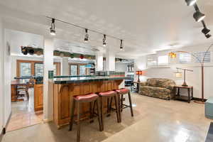 Bar with concrete floors and track lighting