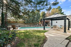 View of pool featuring a fenced in pool, a gazebo, and a fenced backyard