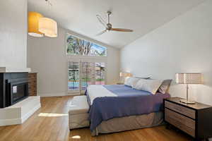 Primary Bedroom featuring baseboards, light wood finished floors, ceiling fan, and high vaulted ceiling
