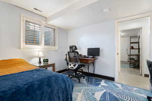 Bedroom featuring baseboards and visible vents