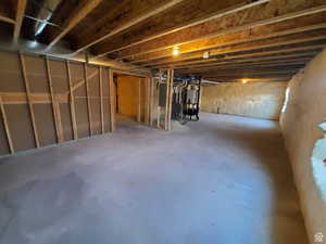Unfinished below grade area featuring water heater