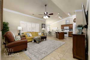 Living area featuring crown molding, ceiling fan, and vaulted ceiling