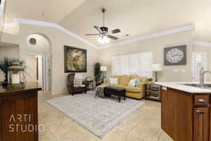 Living room with ceiling fan, lofted ceiling, ornamental molding, and arched walkways