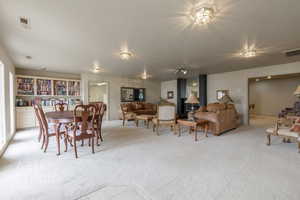 Dining space featuring light carpet