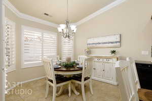 Dining space featuring a chandelier, crown molding, and light tile patterned floors