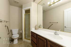 Bathroom featuring vanity and a stall shower
