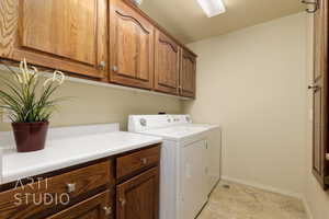 Laundry room featuring cabinet space and washing machine and dryer